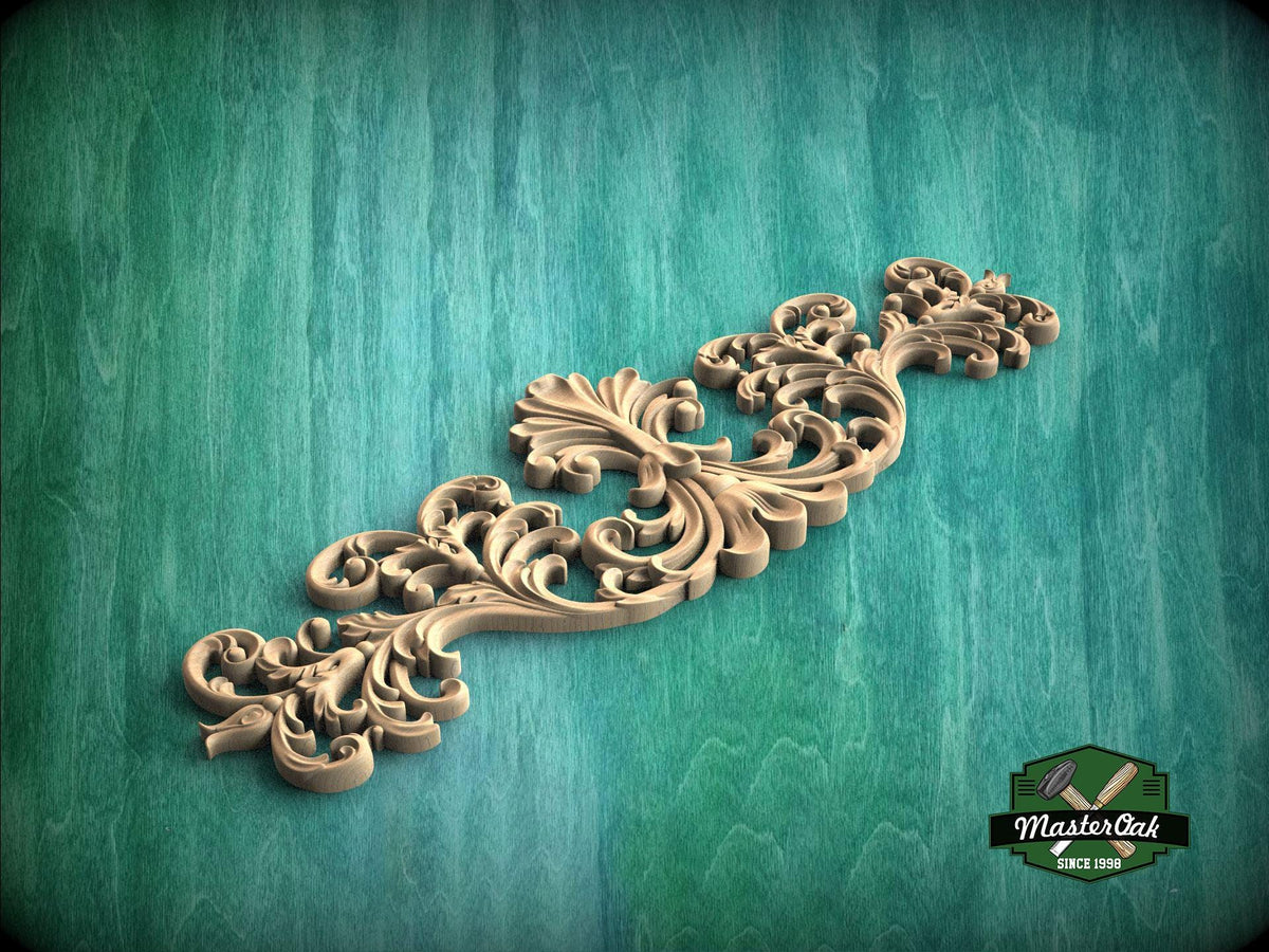 A decorative wooden carving with intricate scrollwork is displayed against a teal background.