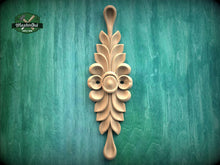 Load image into Gallery viewer, A decorative wooden carving with a floral design is displayed against a green background.
