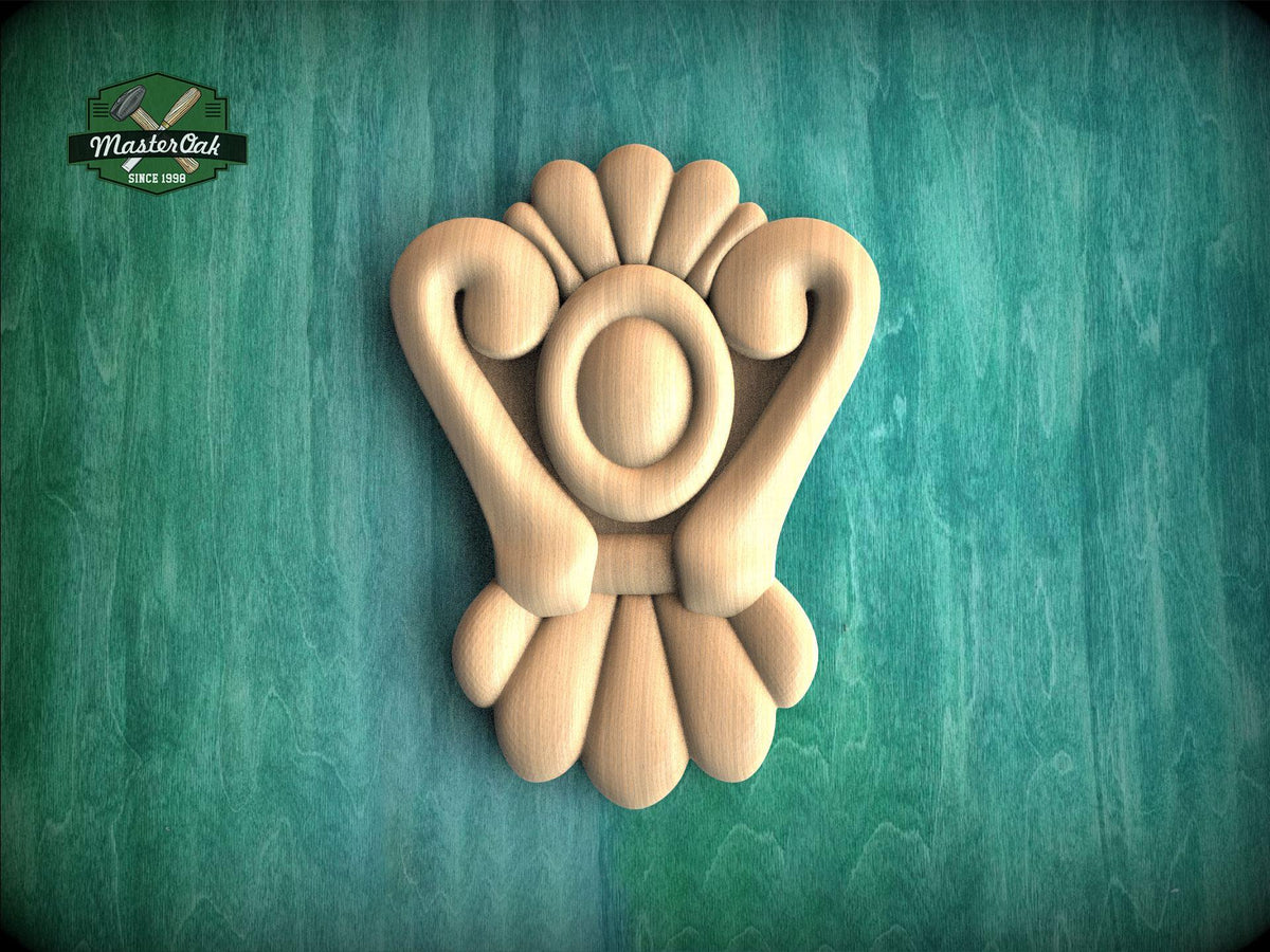 A wooden carving of a stylized flower or floral design is displayed against a green background.
