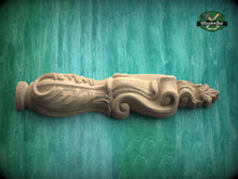 Load image into Gallery viewer, A wooden carving with intricate scrollwork is displayed against a green background.
