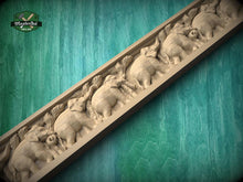 Load image into Gallery viewer, A carved wooden panel with a repeating pattern of elephants, set against a green background.
