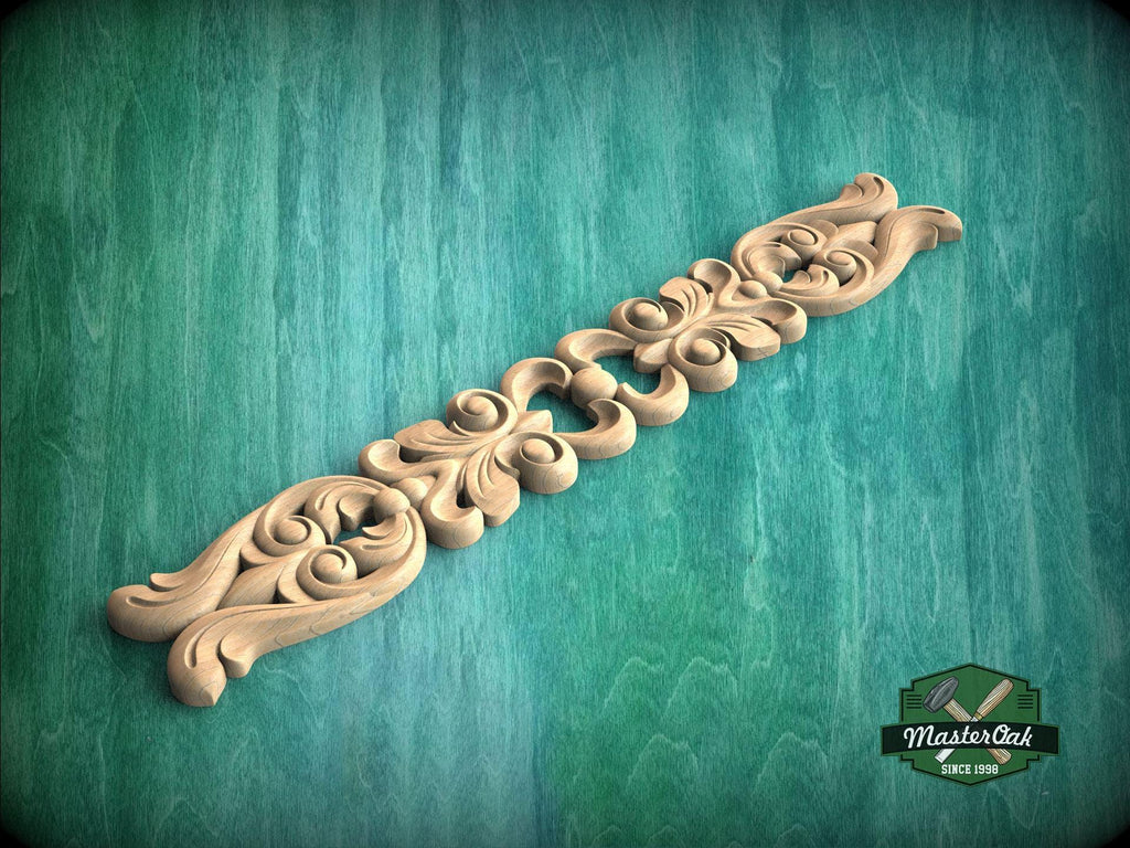 A decorative wooden carving with intricate scrollwork is displayed against a green background.