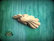 Load image into Gallery viewer, A wooden carving of a leaf-like shape is displayed against a green background.
