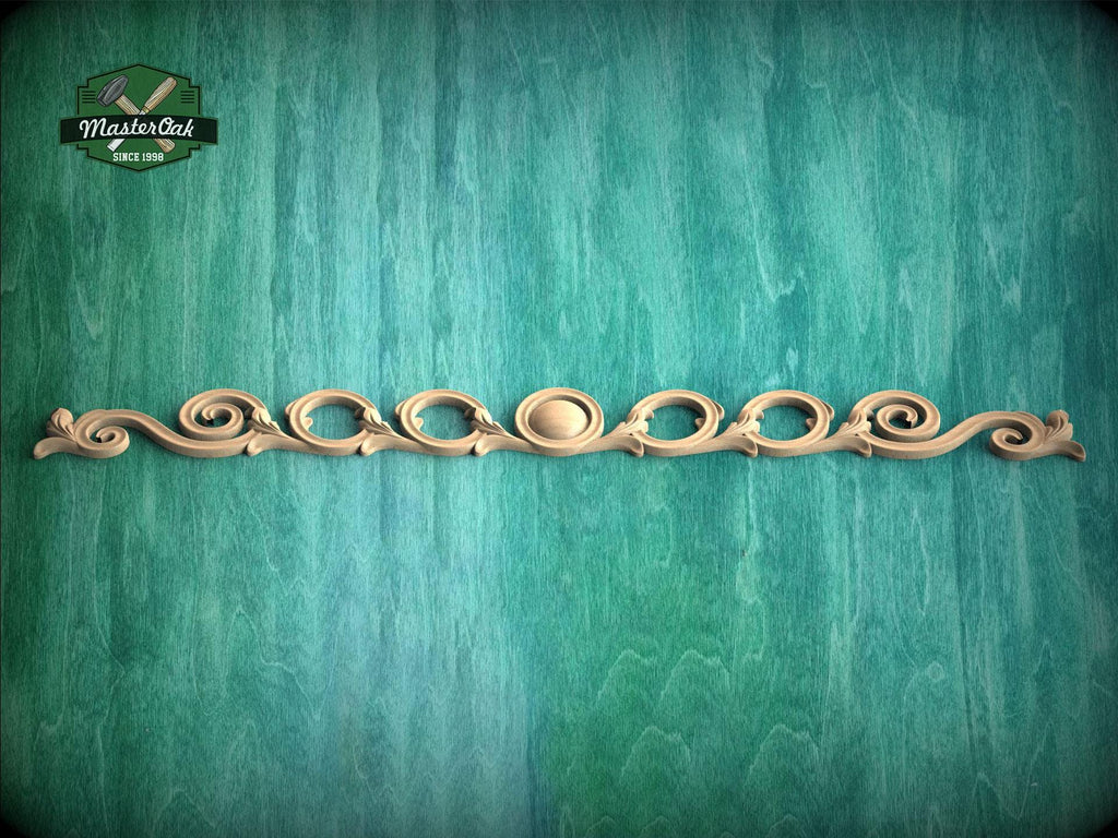 a decorative wooden molding with a curved design on a green background.
