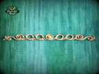 a decorative wooden molding with a curved design on a green background.