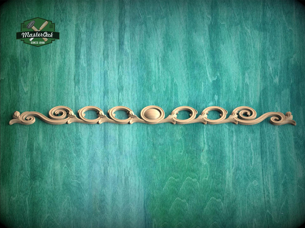 a decorative wooden molding with a curved design on a green background.