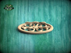 A wooden decorative piece with a floral design is displayed against a textured green background.
