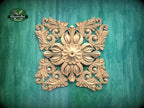 a decorative golden floral pattern on a green background.