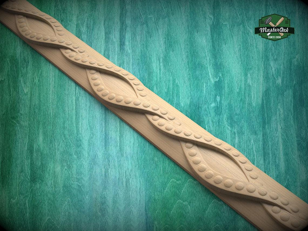 A decorative wooden border with a repeating pattern of curved lines and circular shapes, set against a green wooden background.