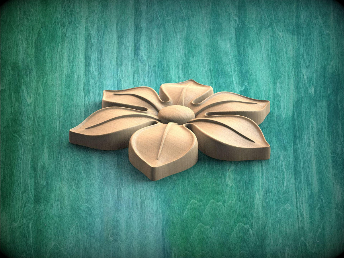 A wooden flower carving is displayed against a green wooden background.