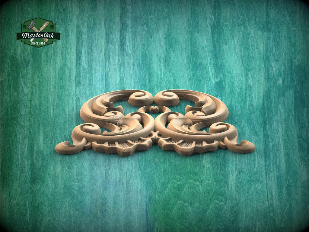 A decorative wooden carving with intricate scrollwork is displayed against a textured green background.