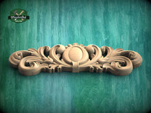 Load image into Gallery viewer, a wooden carving of a flower on a green background
