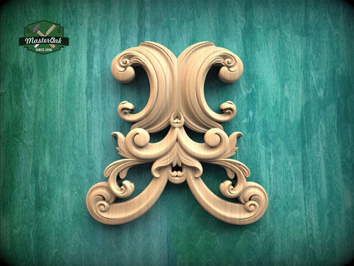 an ornate, carved wooden piece with intricate scrollwork and floral designs, set against a green background.