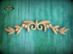 a wooden carving of leaves on a green background