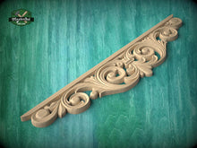 Load image into Gallery viewer, A decorative wooden carving with intricate scrollwork is displayed against a teal background.
