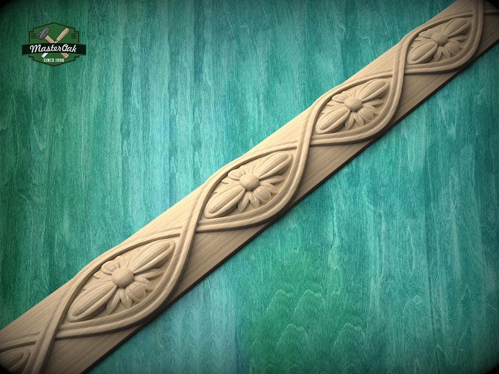 A decorative wooden border with intricate floral designs is displayed against a green wooden background.