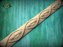 Load image into Gallery viewer, A decorative wooden border with intricate floral designs is displayed against a green wooden background.
