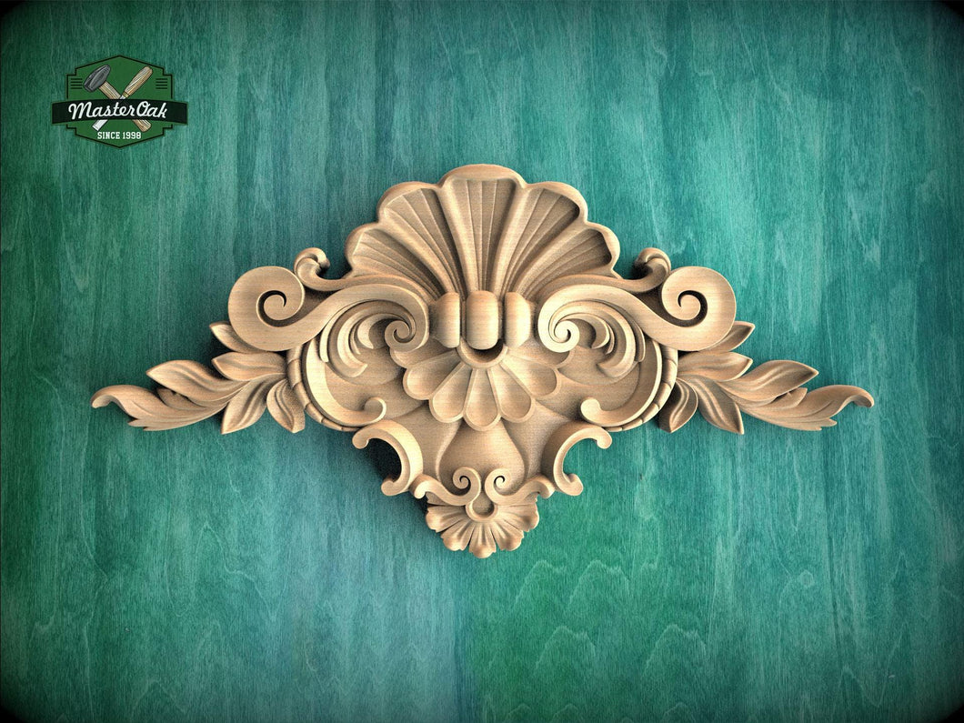 a beautifully carved wooden ornament with intricate floral and scroll designs, set against a green background.