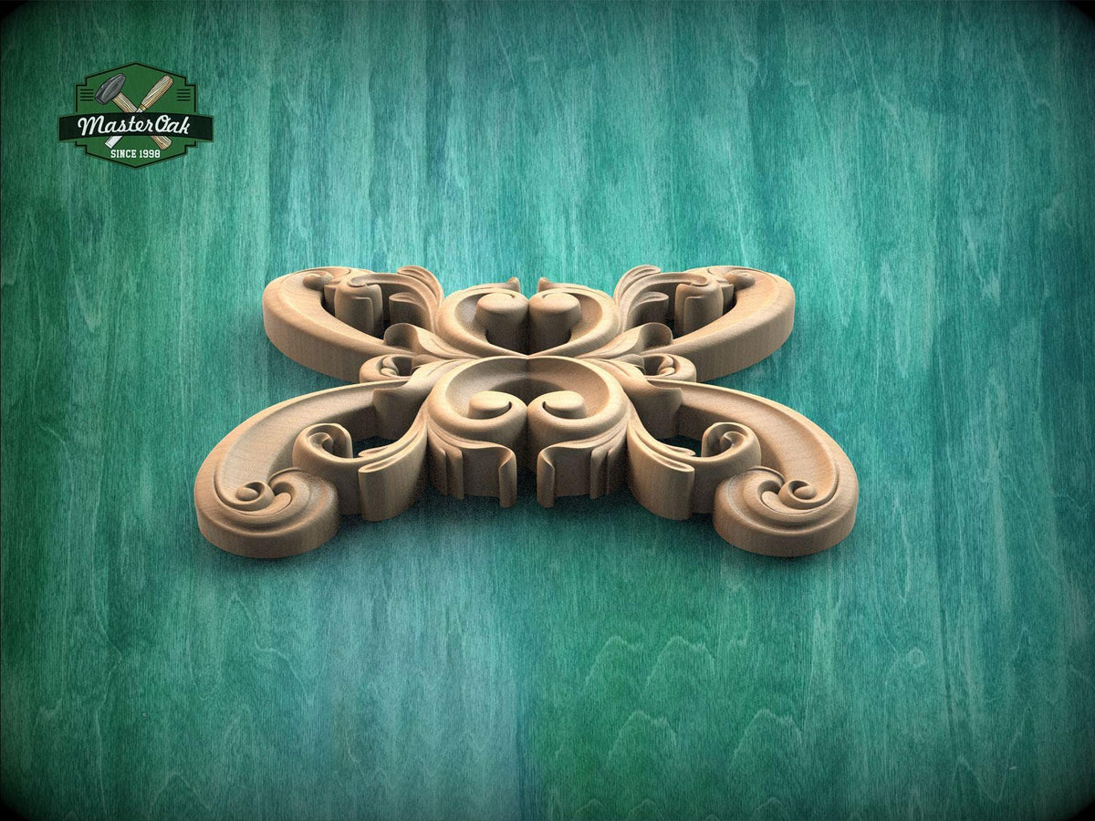 A decorative wooden carving in the shape of a butterfly or flower, with intricate swirls and curves, is displayed against a green background.