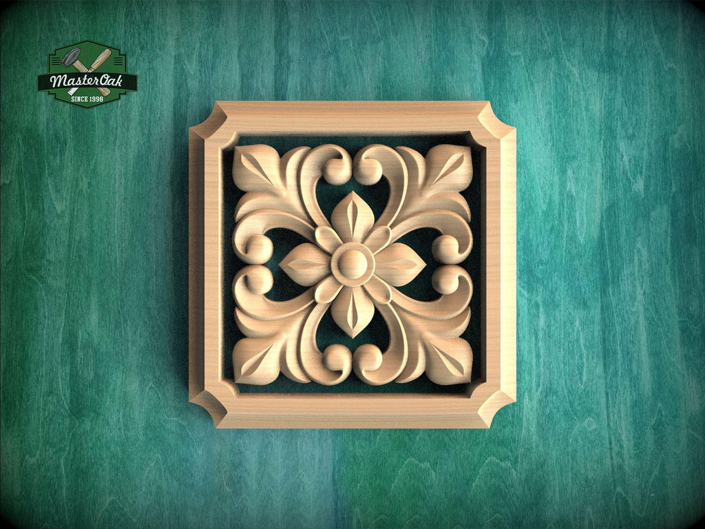 a square wooden carving with an intricate floral design, set against a green background.