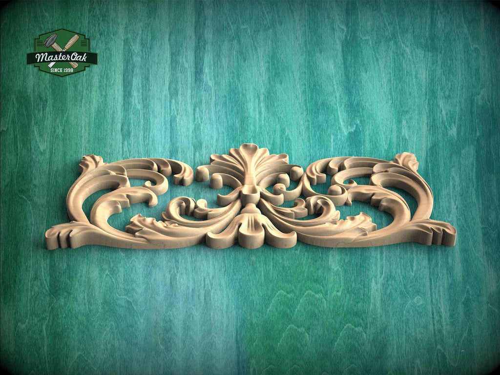 A decorative wooden carving with intricate scrollwork is displayed against a green wooden background.