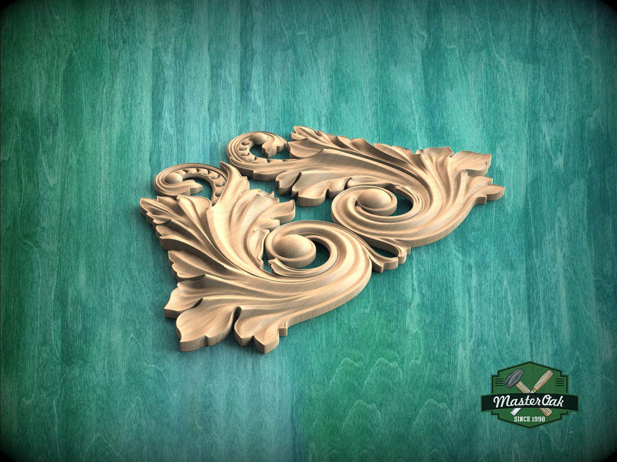 A decorative wooden carving in the shape of a leaf with intricate scrollwork is displayed against a green textured background.