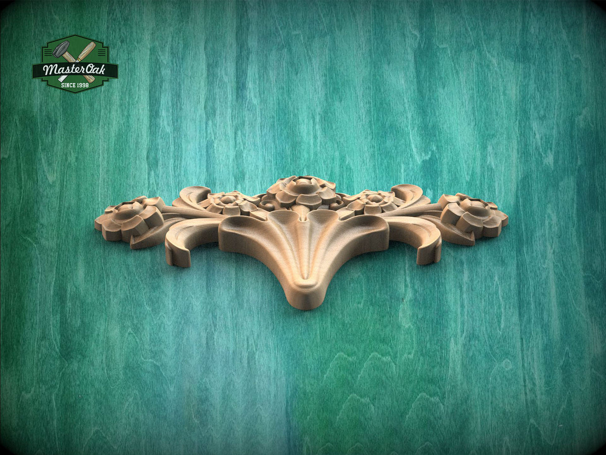 A decorative wooden carving with a floral design is displayed against a green wooden background.
