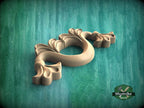 A wooden carving of a stylized flower or plant with intricate details is displayed against a green background.