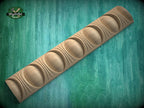 A wooden carving with a curved, organic shape is displayed against a green background.