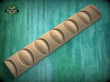 Load image into Gallery viewer, A wooden carving with a curved, organic shape is displayed against a green background.
