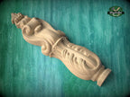 A wooden carving of a decorative finial or finial-like object is shown against a green background.