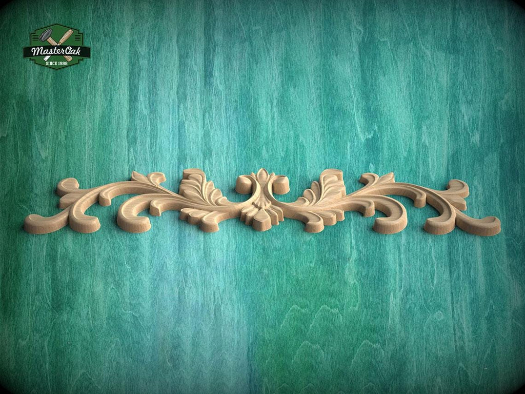 A decorative wooden carving with an ornate, floral design is displayed against a textured green background.