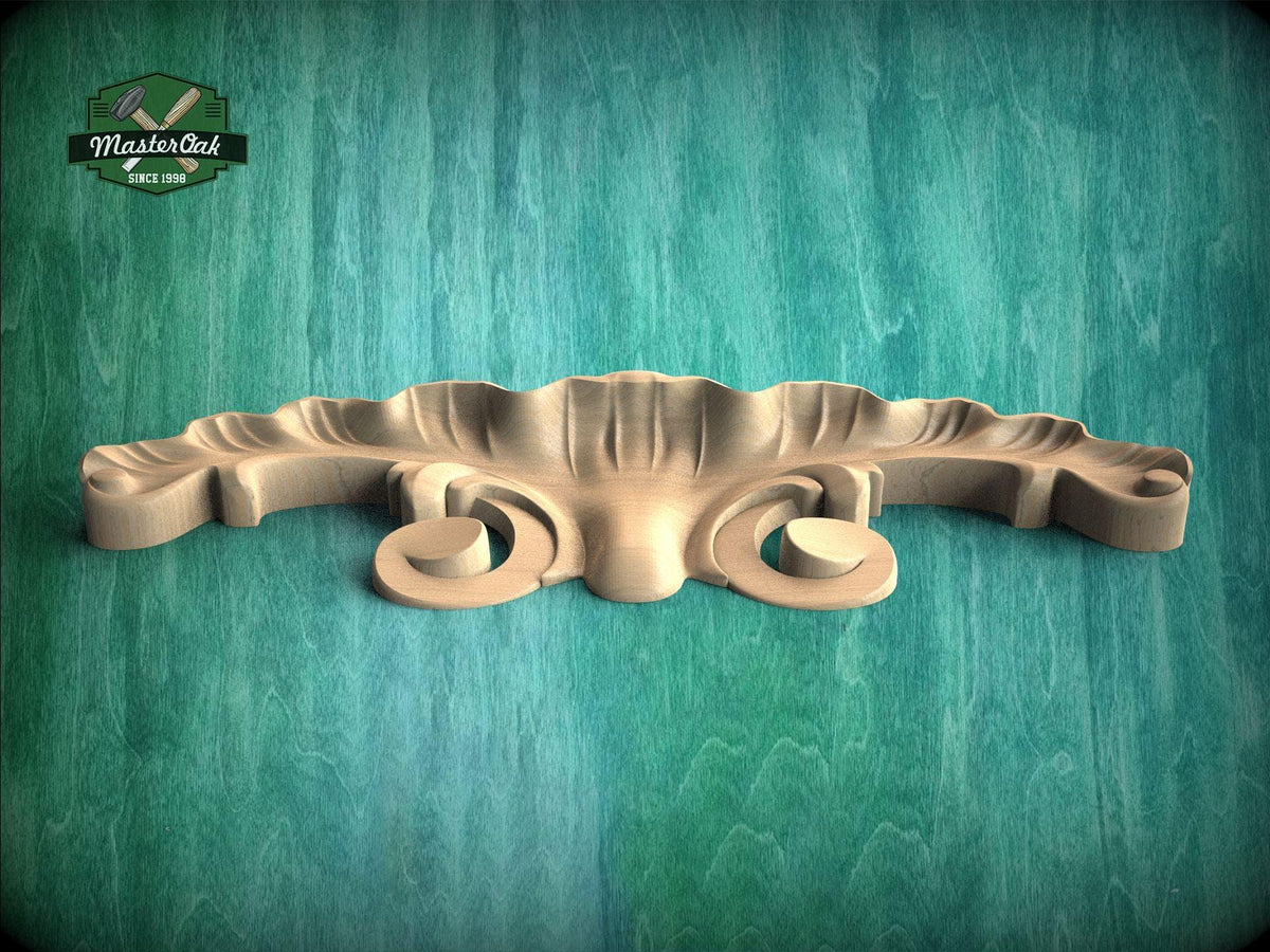 A wooden carving or mold is displayed against a green background.
