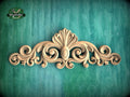 a decorative wooden carving on a green background.