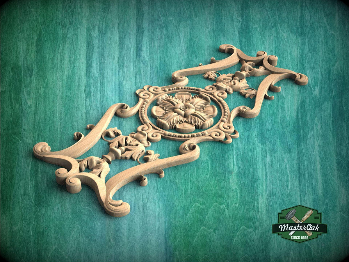 A decorative wooden carving with intricate floral and scrollwork designs is displayed against a green background.