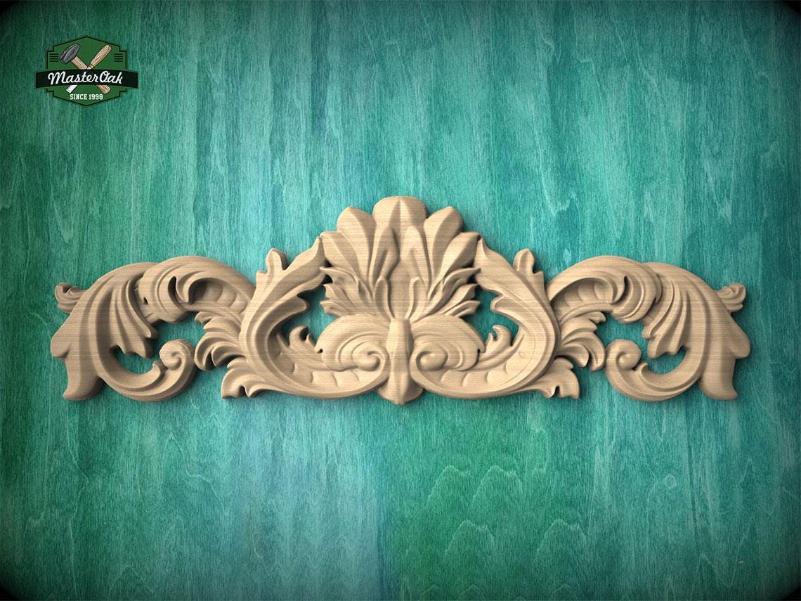 a decorative wooden carving on a green background.