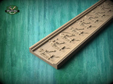Load image into Gallery viewer, A wooden carving of a row of figures on a green background, with a logo for Master Oak visible in the top left corner.
