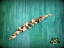 Load image into Gallery viewer, A decorative wooden carving with a scroll-like design is displayed against a green textured background.
