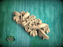Load image into Gallery viewer, A wooden carving of a flower design is displayed against a green background.
