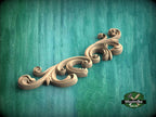 a wood carving of a scroll on a green background
