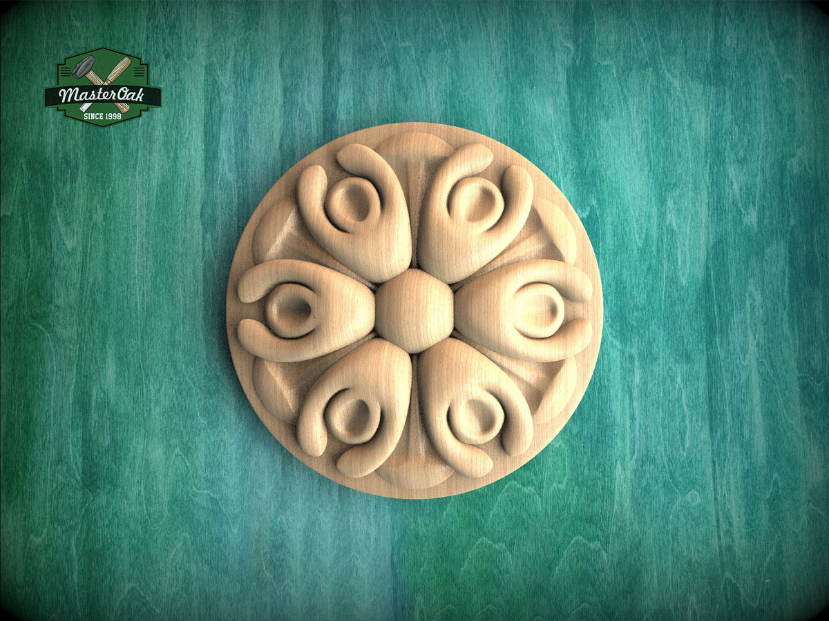 A wooden ornamental piece with a floral design, placed on a green wooden surface.