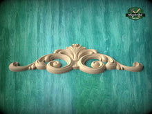 Load image into Gallery viewer, A decorative wooden carving in the shape of a scroll adorns a turquoise background.
