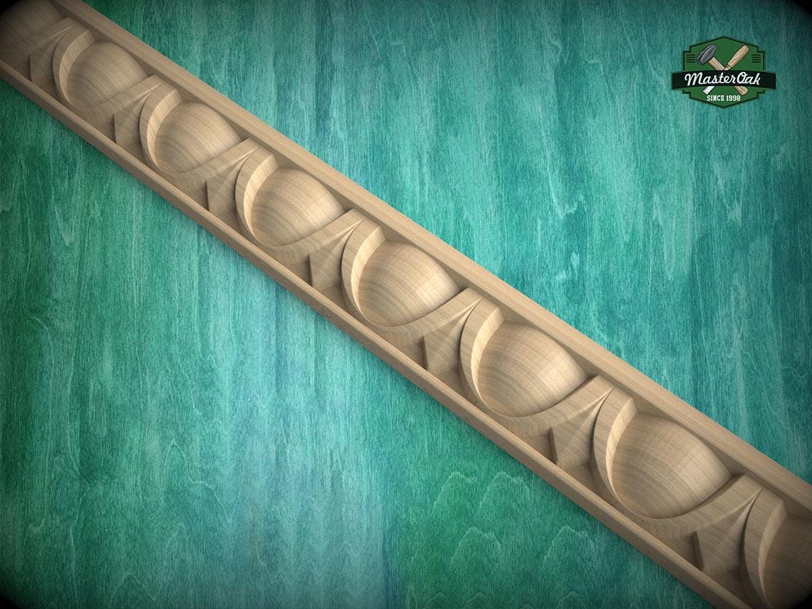 A decorative wooden molding with a curved design is displayed against a green textured background.