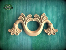 Load image into Gallery viewer, A decorative wooden carving with a floral design is displayed against a green background.

