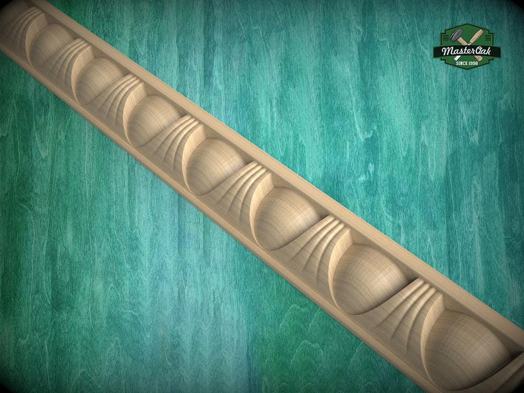 A decorative wooden molding with a repeating pattern of curved shapes is displayed against a green textured background.