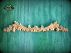a wood carving of flowers and leaves on a green background
