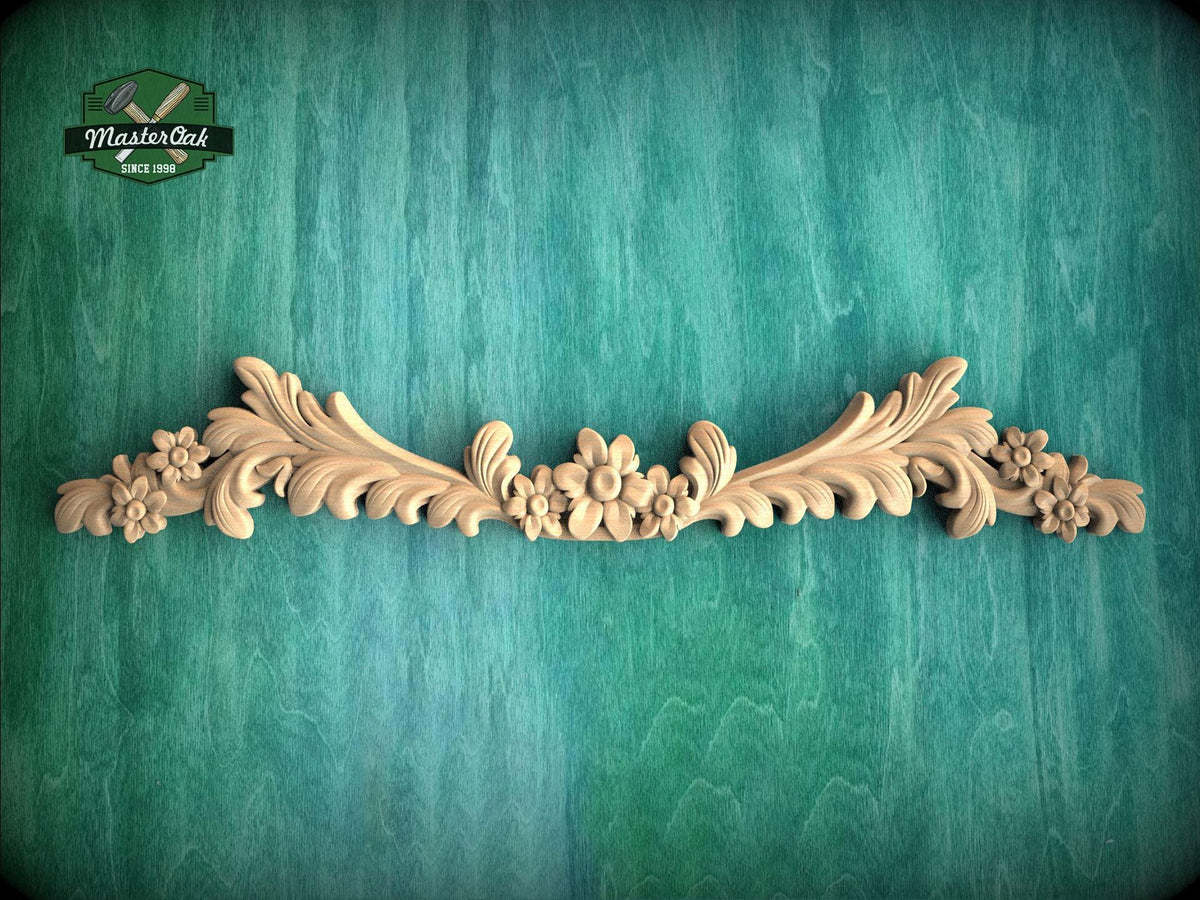 a wood carving of flowers and leaves on a green background