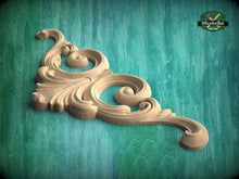 Load image into Gallery viewer, A decorative wooden carving with an intricate, swirling design is displayed against a teal background.
