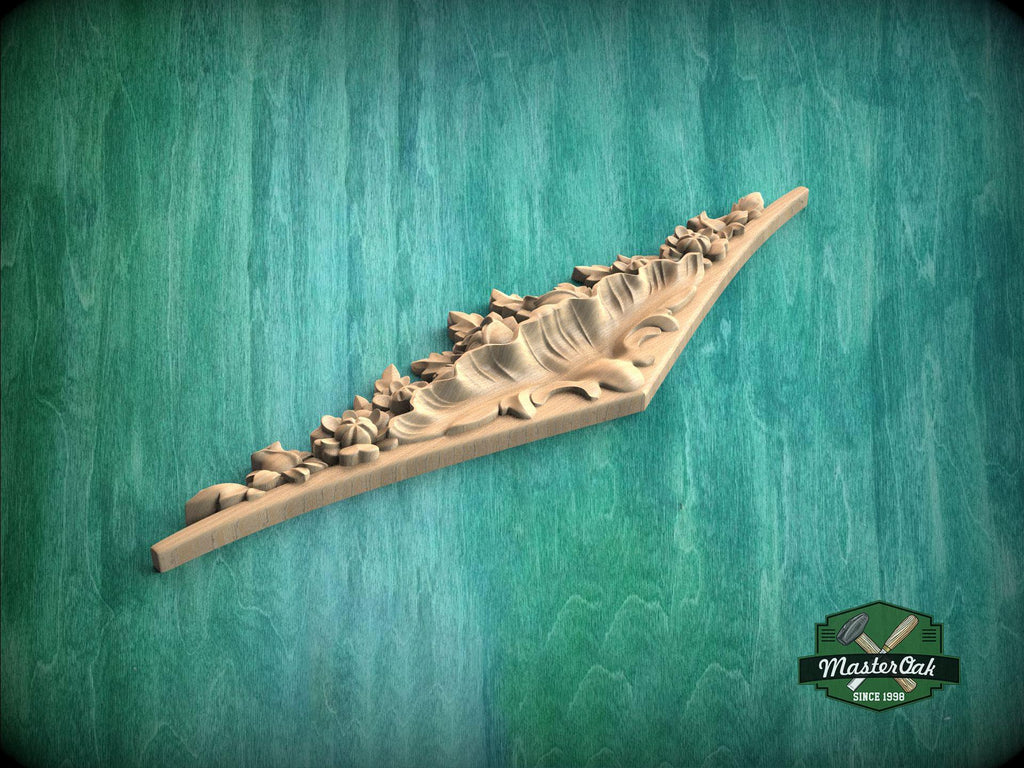 A wooden carving with a floral design is displayed against a green background.
