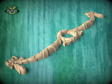 Load image into Gallery viewer, A wooden carving of a dragon-like creature is displayed against a teal-colored background.
